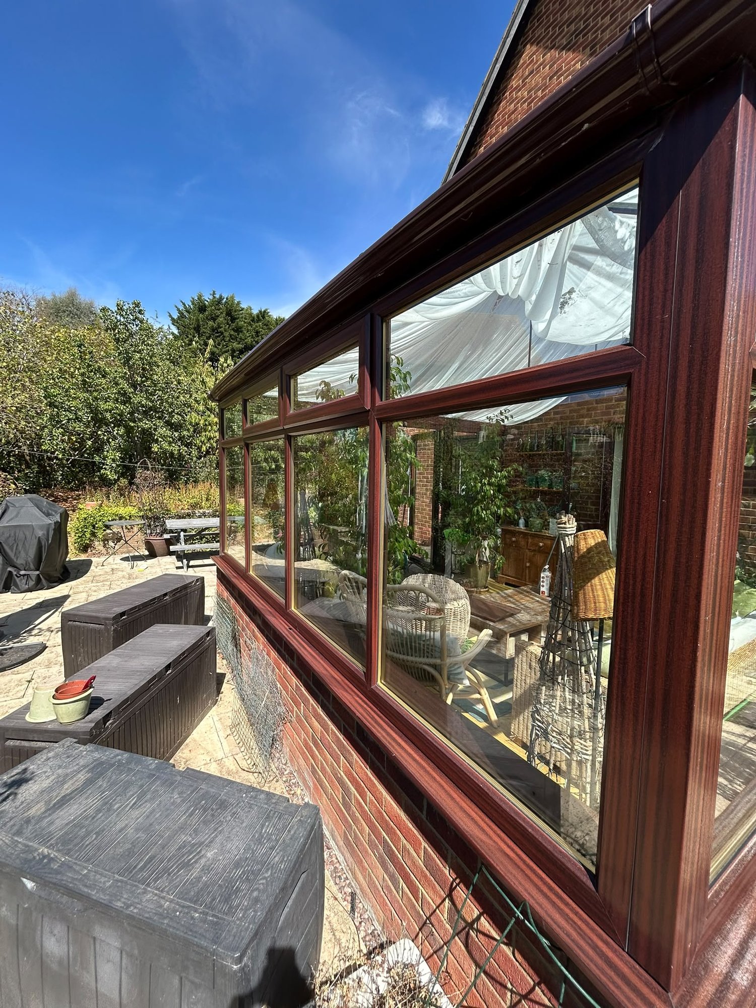 Cleaned conservatory glazing on a red brick house
