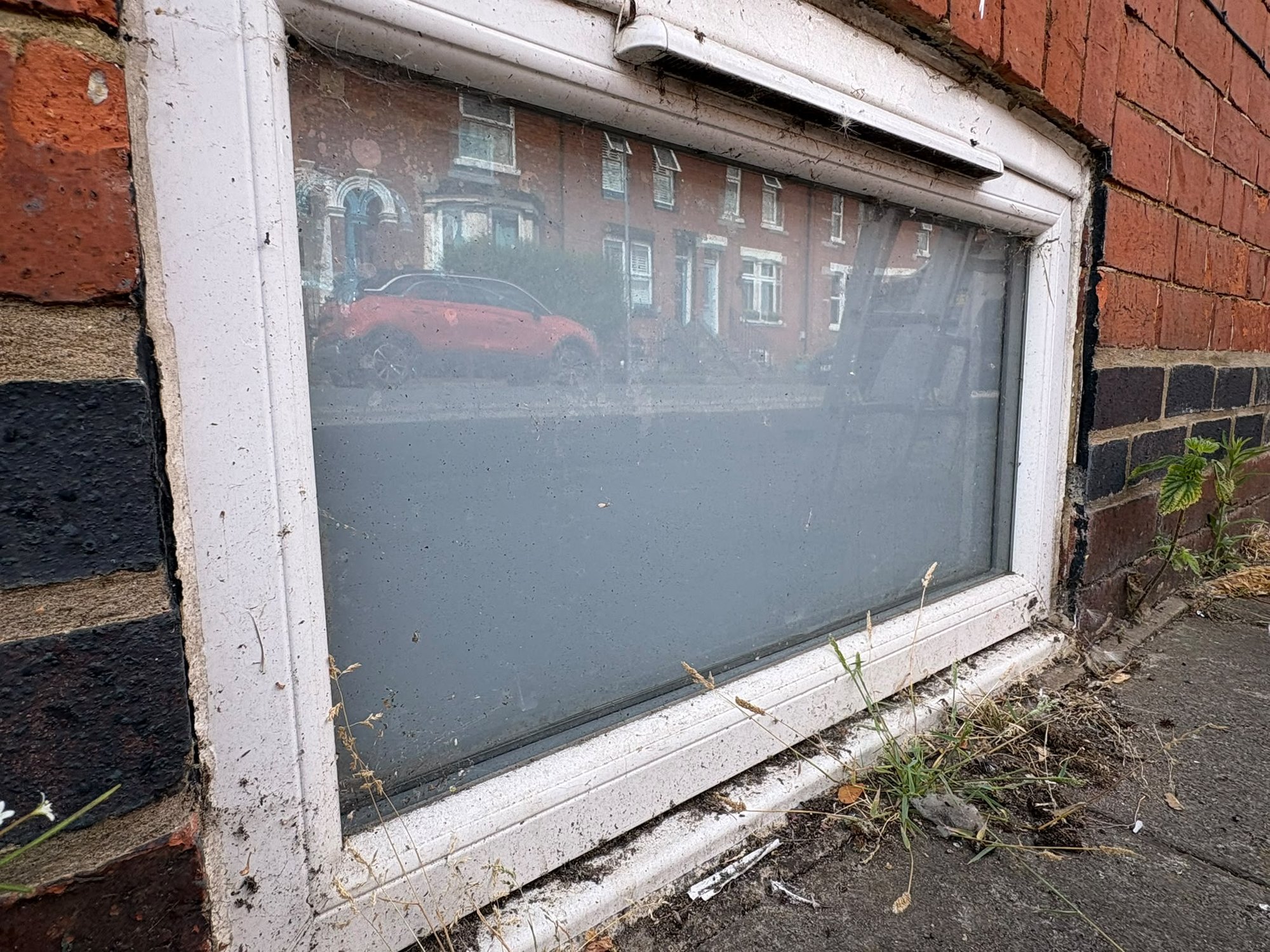 Window before cleaning, dirty glass and frames